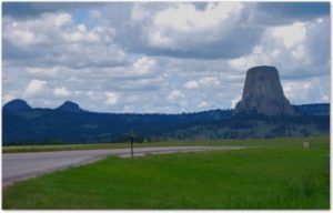 Looking West: Devil’s Tower (and the Missouri Buttes, on the left) formed from volcanic activity underground millions of years ago. Local uplift and the erosion of the softer sediments surrounding the Tower of granite led to its exposure.